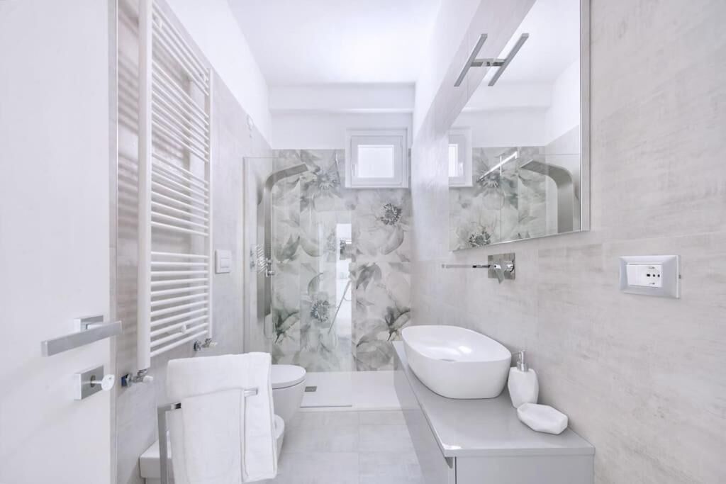 A modern bathroom with a toilet, bidet, and a large sink.