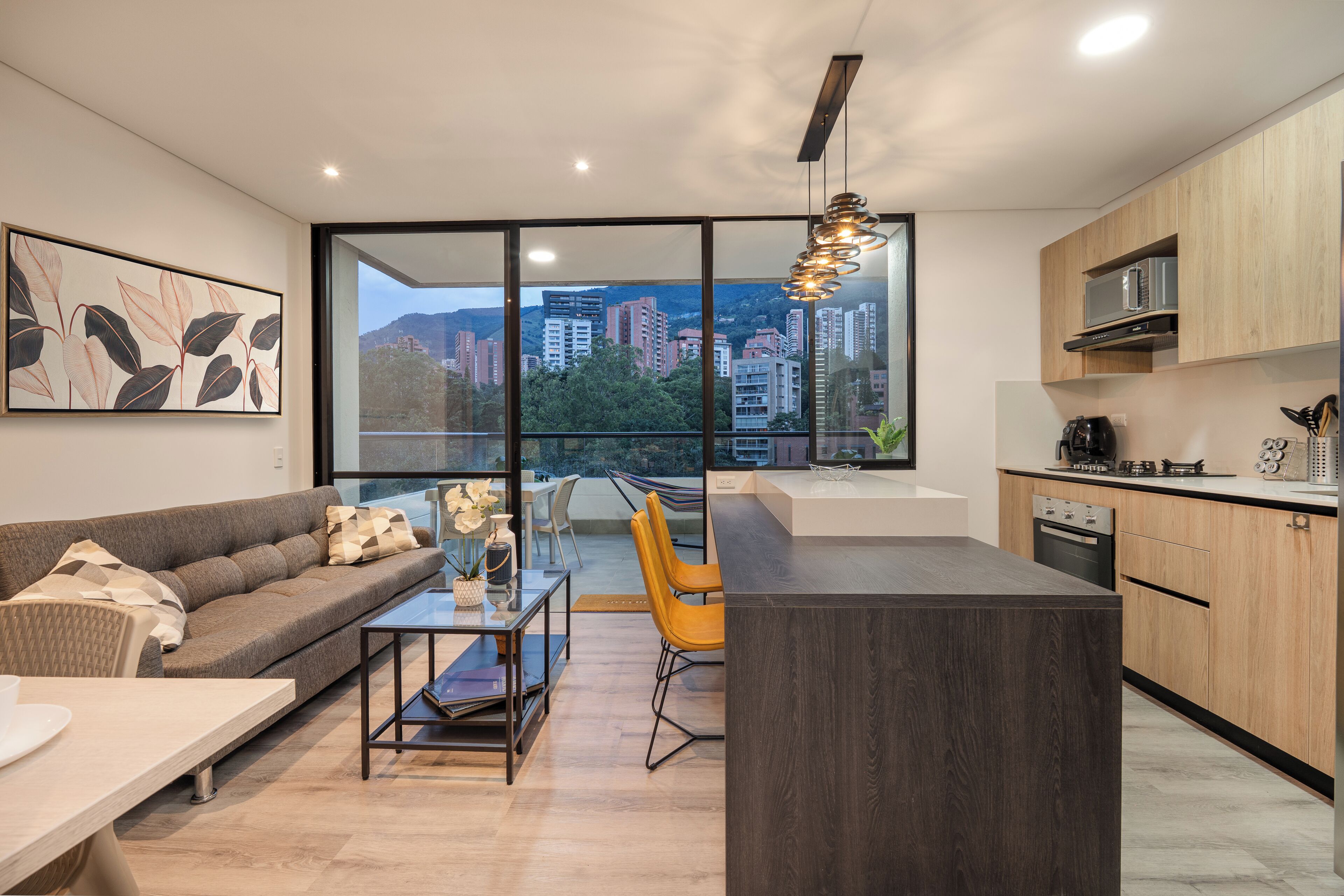 A modern apartment with a kitchen, dining area, and living room.