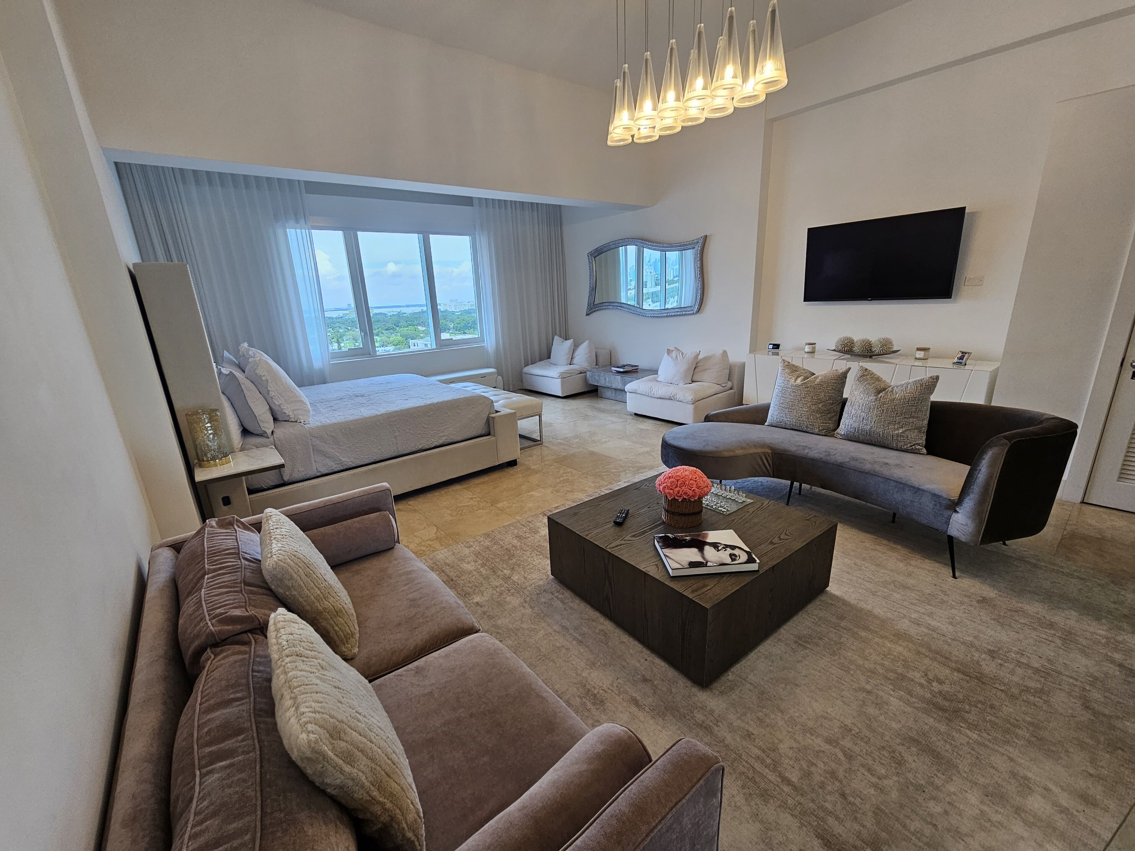 A modern living room with a sofa, a coffee table, and a TV.