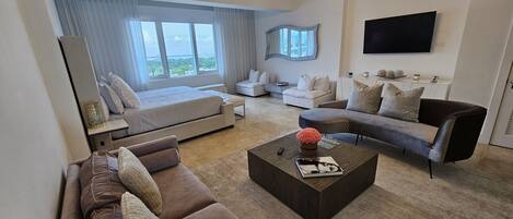 A modern living room with a sofa, a coffee table, and a TV.