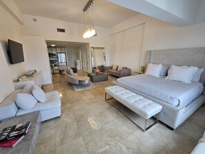 A modern bedroom with a large bed, a sofa, a chair, and a coffee table. - Sunset Loft Oasis/ Bright & Airy/ One hotel Living (Miami Beach)