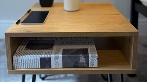 A bedside table with a lamp, a smartphone, a notebook, a potted plant, and a newspaper. - Walk to Train Bolton ~Free Parking ~close to Shops (Farnworth)