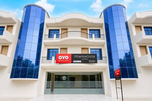 A hotel with a modern facade, featuring a prominent sign for OYO TOWNHOUSE HOTEL. - Classic Prayagraj New Cantt (Prayagraj)