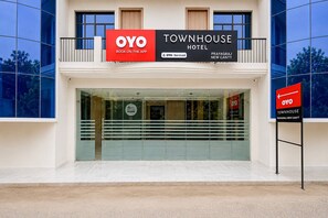 A modern building with a large glass entrance, a prominent OYO Townhouse Hotel sign, and a sign indicating the location as Prayagraj New Cantt. - Classic Prayagraj New Cantt (Prayagraj)