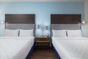 A hotel room with two beds, a nightstand, and a lamp between them. - Tru By Hilton Chattanooga West Lookout Mountain (Chattanooga)