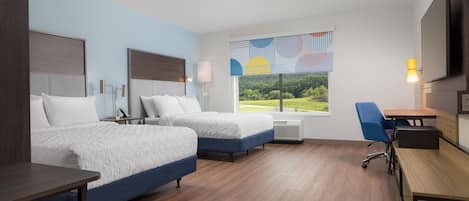 A hotel room with two beds, a desk, a chair, a flat-screen TV, and a large window with a view of greenery.