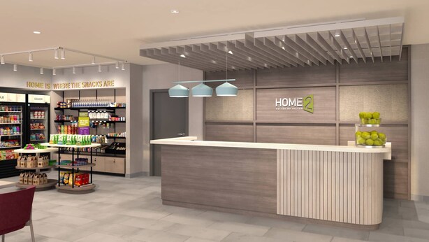 Uma área de recepção de hotel com design moderno, incluindo um balcão de atendimento, um espaço para exposição de alimentos e uma área de estar.