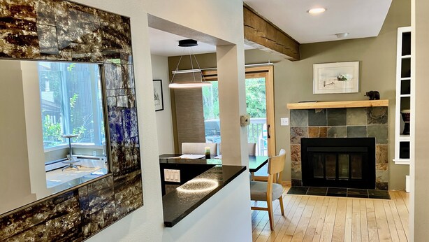 A modern interior with a kitchen counter, a fireplace, and a dining area. -  3bd-2ba stand alone condo with POOL and no hwy noise 5 min- Vail Village (Vail)