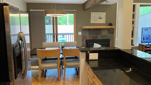 A modern kitchen with a dining area, a fireplace, and a television. -  3bd-2ba stand alone condo with POOL and no hwy noise 5 min- Vail Village (Vail)