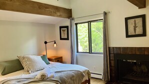 A bedroom with a bed, bedside table, lamp, window, fireplace, and a framed picture on the wall. -  3bd-2ba stand alone condo with POOL and no hwy noise 5 min- Vail Village (Vail)
