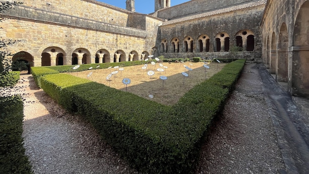 A courtyard with stone walls, arched walkways, and a central garden with flower beds. - Le Clos du Thoronet (Le Thoronet)