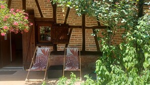 A rustic building with exposed wooden beams and a brick wall.