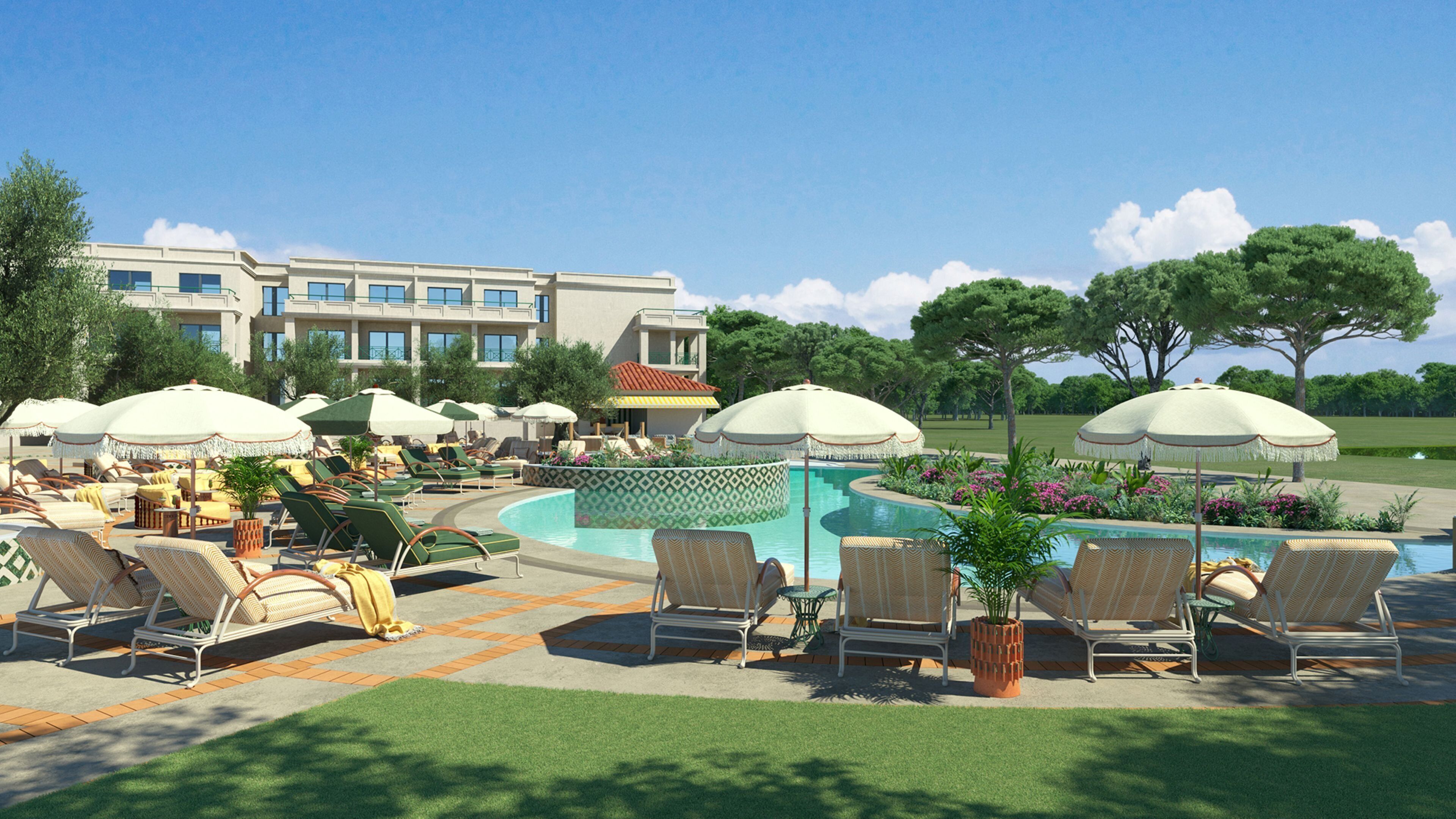A poolside area with lounge chairs, umbrellas, and a swimming pool.