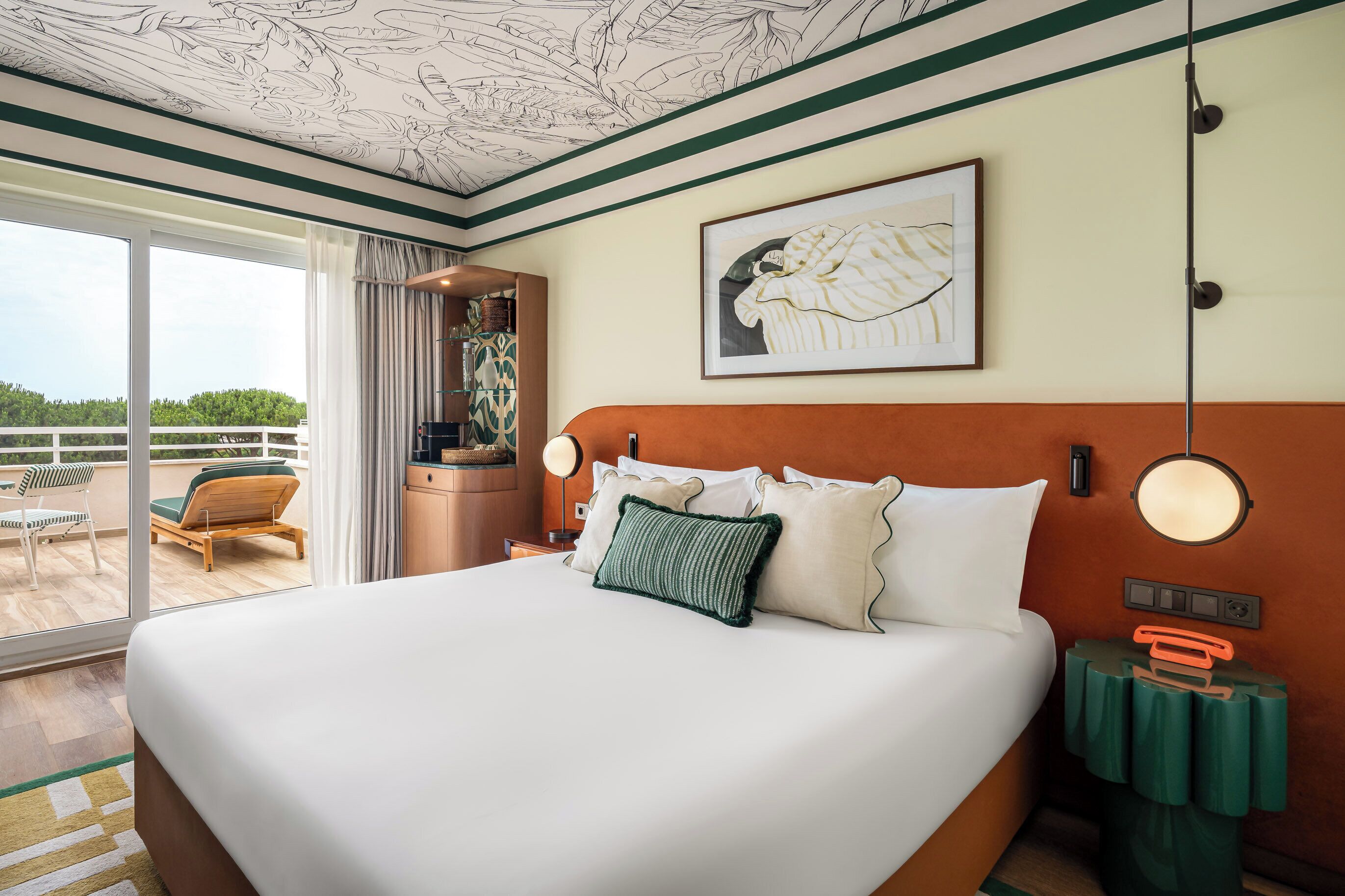 A hotel room with a large bed, a view of the outdoors, a dining area, and a bathroom.