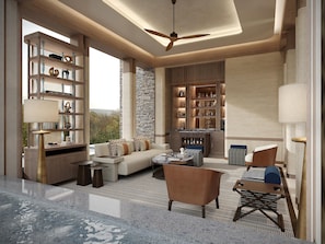 A modern living room with a sofa, chairs, a coffee table, and a bookshelf.