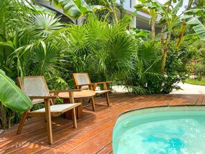 A wooden deck with a pool, surrounded by lush tropical plants. - Xperience Tulum 25 (Tulum)