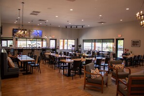 A spacious restaurant with multiple dining areas, large windows, and a bar counter. - 1BR Condo w/ Private Balcony & Full Kitchen (Branson)