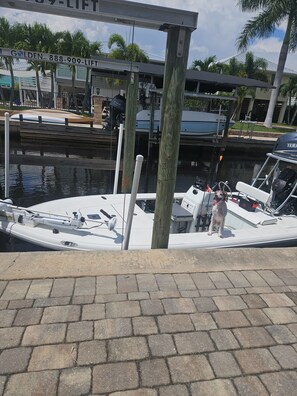 A boat docked at a marina with a wooden post in the foreground. - Boaters dream! Waterfront home in Bonita Springs - Estero Bay in minutes (Bonita Springs)