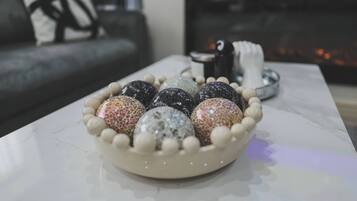 A bowl of decorative eggs on a marble table.