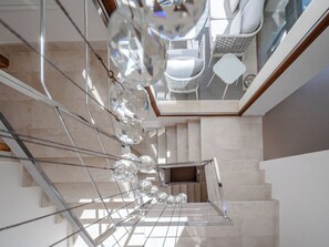 A modern interior with a staircase, glass railings, and white furniture. - Vacation home Bartok by Interhome (Jávea)