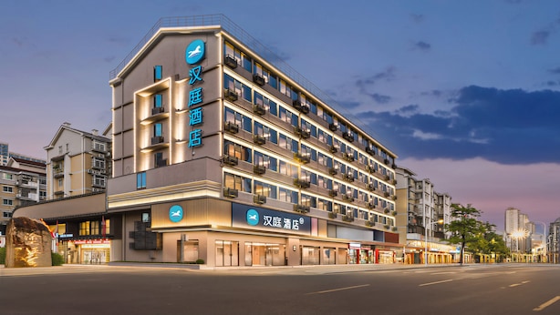 A multi-story hotel with balconies, a prominent sign, and a modern facade.