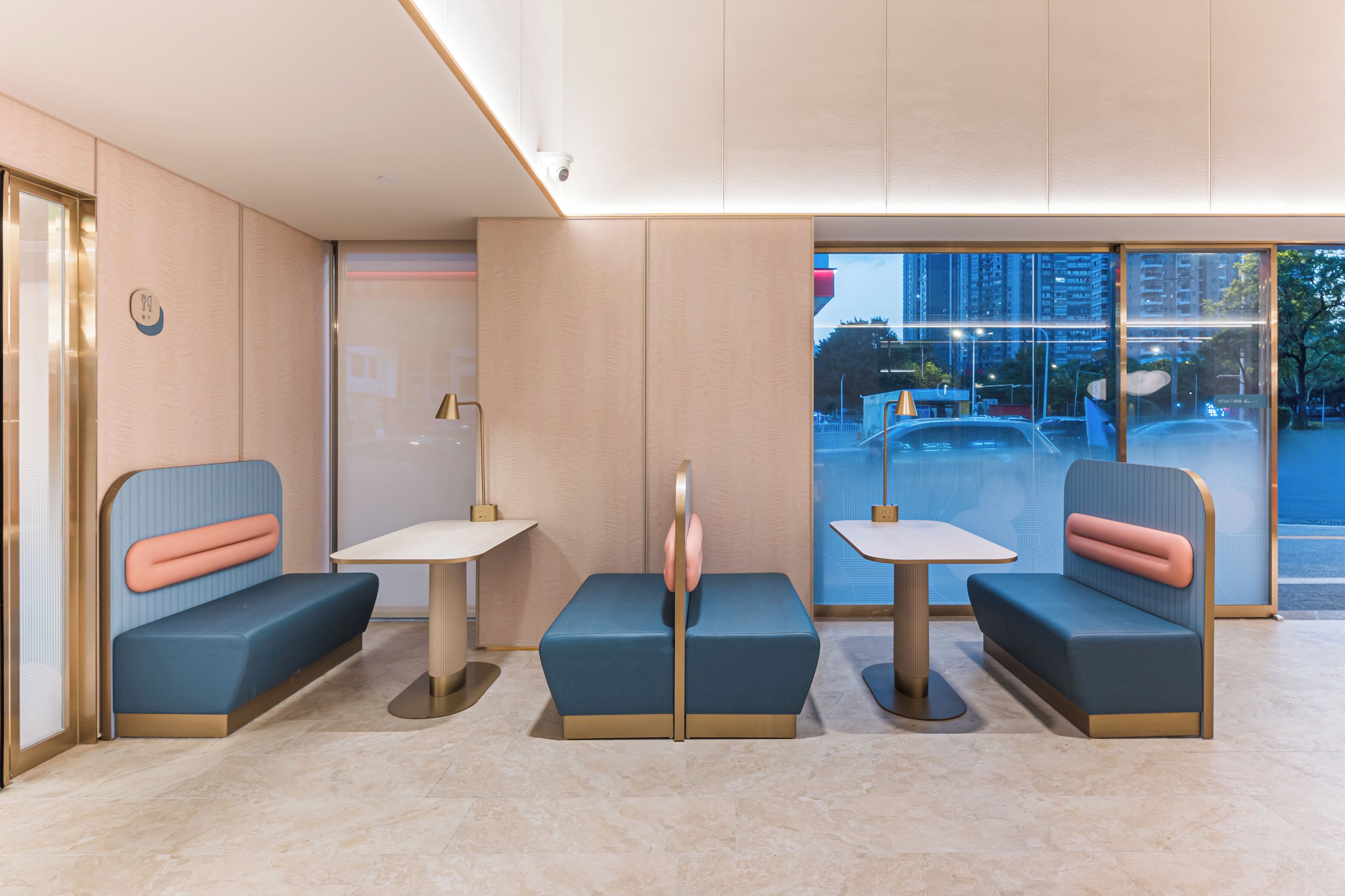 A modern interior with seating arrangements and a view of the outside.