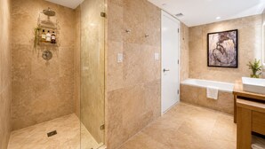 A modern bathroom with a glass-enclosed shower, a white bathtub, and a wooden vanity. - 1-bedroom hotel suites in amazing Miami Beach with fitness room (Miami Beach)