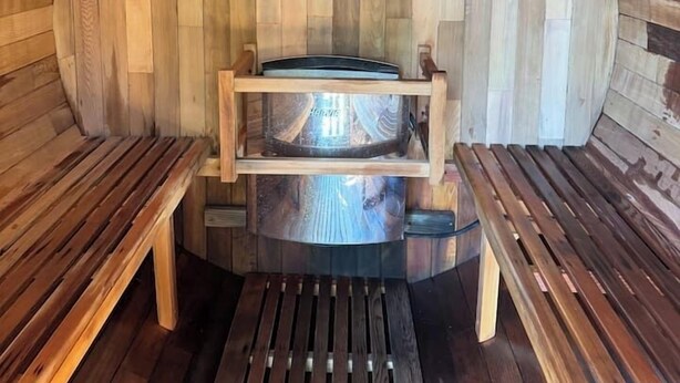 Un sauna avec des murs et des bancs en bois.