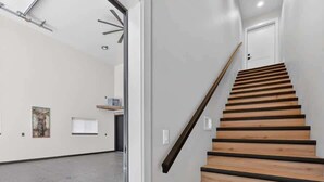 A staircase with wooden steps and a handrail, leading to a door at the top. - Sturgeon Bay Boat Condo w Marina Slip (Sturgeon Bay)