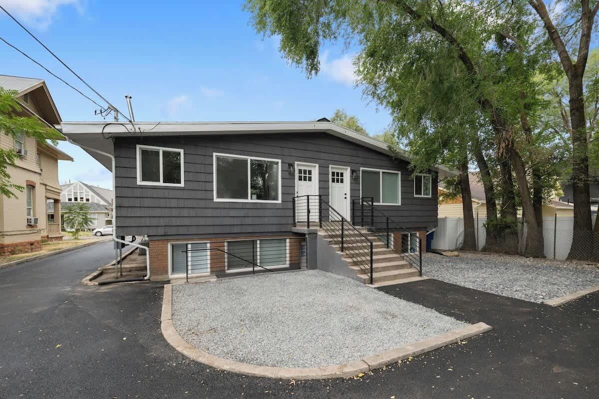 A two-story house with a front entrance, a covered porch, and a driveway.