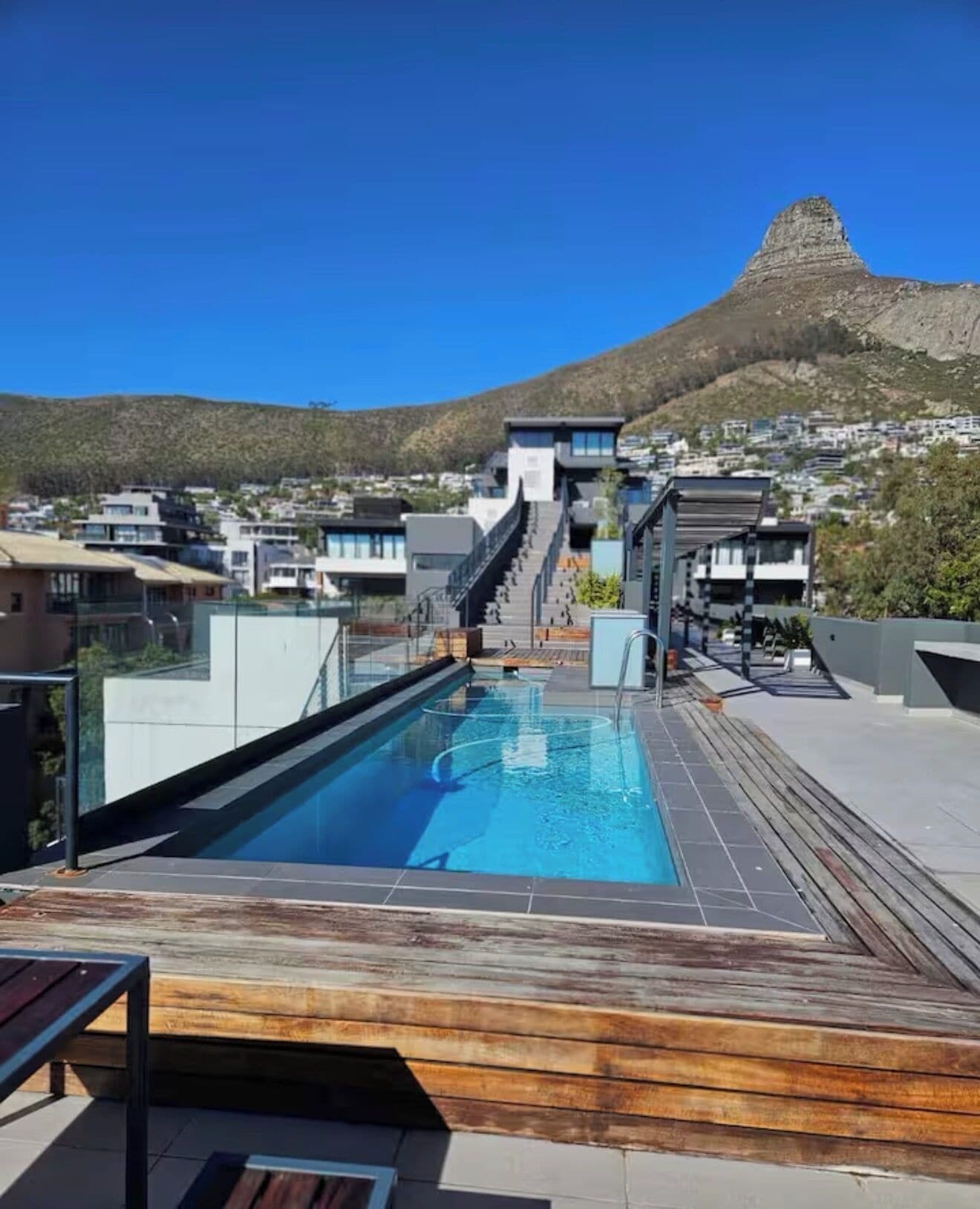 A rooftop pool with a clear view of a mountain in the background.