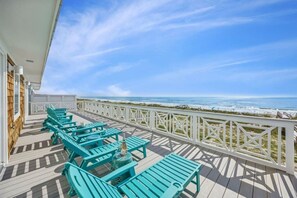 A deck with outdoor seating and a view of the ocean. - Driftwood Dunes | Brand New Oceanfront Beach House | Hot Tub | Elevator | EV Charger | Sleeps 17 (Fernandina Beach)