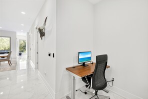 A modern office space with a desk, chair, and a mounted animal skull on the wall. - 52 audubon (Sarasota)