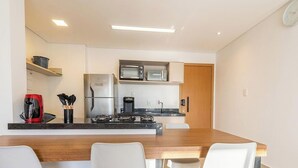 A compact kitchen with a refrigerator, microwave, coffee maker, and a stove. - Apt. in Condo. w/ Pool in Anapolis Grlb1405 (Anapolis)