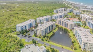Complejo residencial con varias torres, una fuente central y vista al océano.