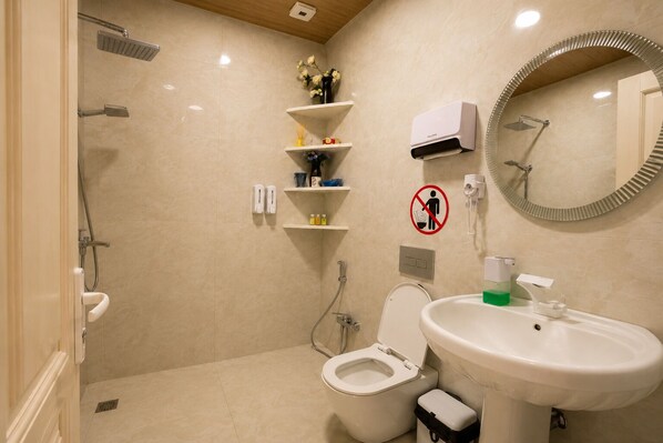 Une salle de bain moderne équipée d’une douche, de toilettes et d’un lavabo.