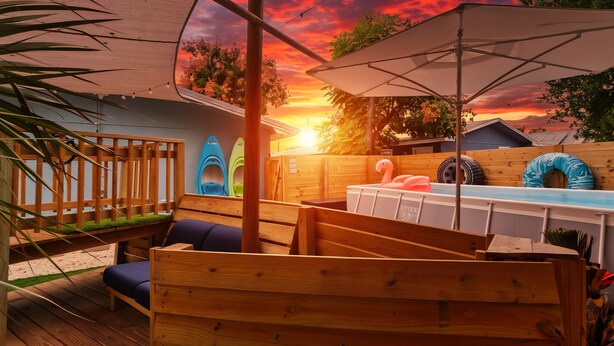 A wooden deck with a pool, lounge chairs, and kayaks. - Double PCB Oasis: Pool/ 2 Hot Tubs/ Arcades/ 2 Golf Carts
Unit A & B Combined (Panama City)