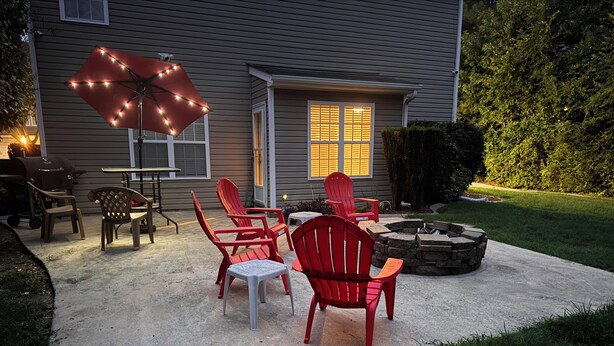 A patio with outdoor furniture, a barbecue grill, and a fire pit.