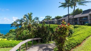 A resort with a pathway leading to a building with a view of the ocean. - Front row for Bali Hai and  BEST sunsets on Kauai  @ Pali Ke Kua (Princeville)