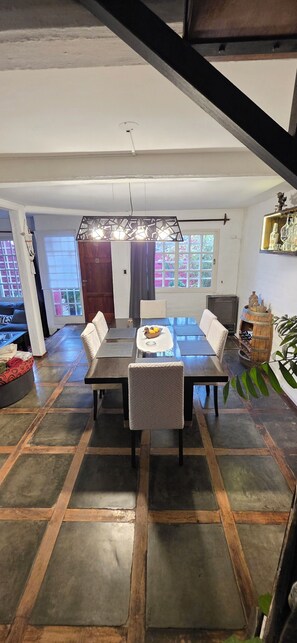 Una zona de menjador amb una taula rectangular, sis cadires i un centre decoratiu.