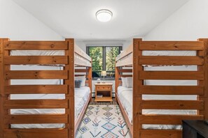 A bunk bed room with a window, a small table, and a patterned rug. - Ski-in ski-out Beaver Creek W/pool and hot tub (Beaver Creek)