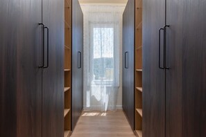 A narrow hallway with wooden wardrobes and a window with sheer curtains. - Villa Ginger | Modern Villa with Private Pool (Tugare)