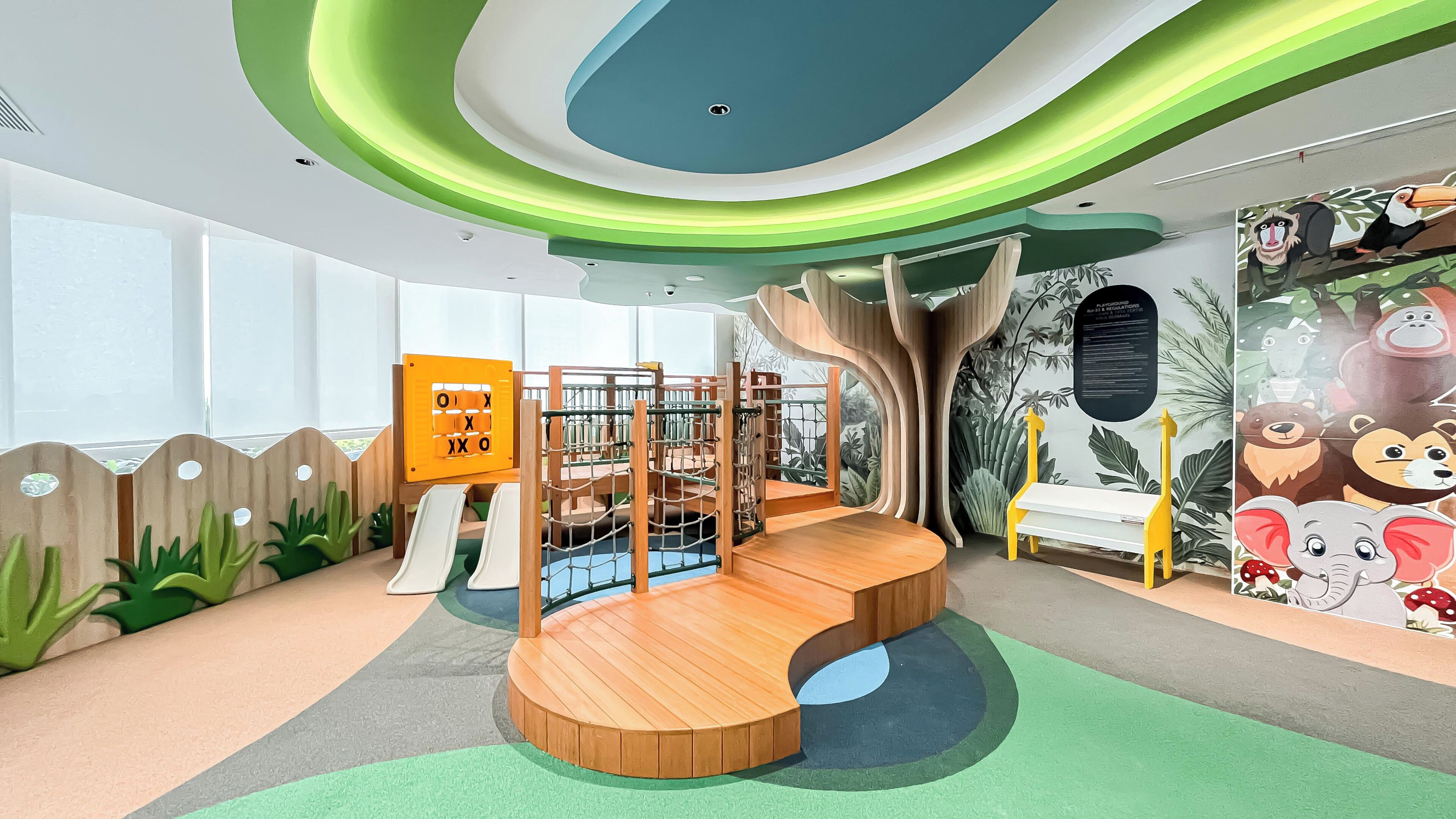 A children's play area with a slide, climbing structures, and a wooden bench.
