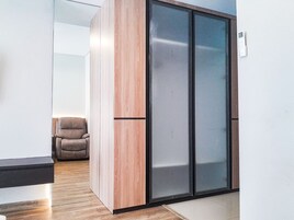 A modern interior with a sliding door, a brown leather chair, and a white wall.