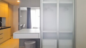 A modern bathroom with a shower, a sink, and a mirror. - Functional Nice Studio Room At Apartment Tamansari Skylounge Balikpapan (Balikpapan)
