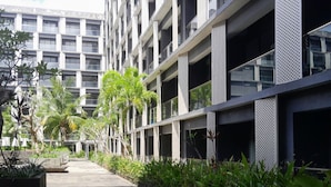 Un edificio moderno de varios pisos con una serie de balcones y ventanas amplias.