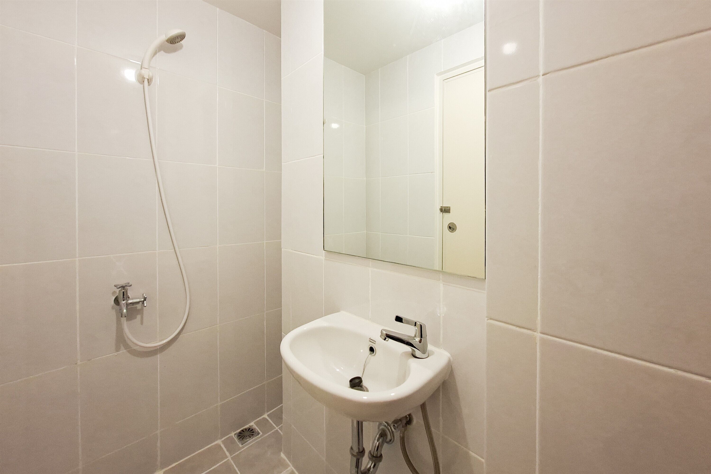 A bathroom with a shower, sink, and mirror.