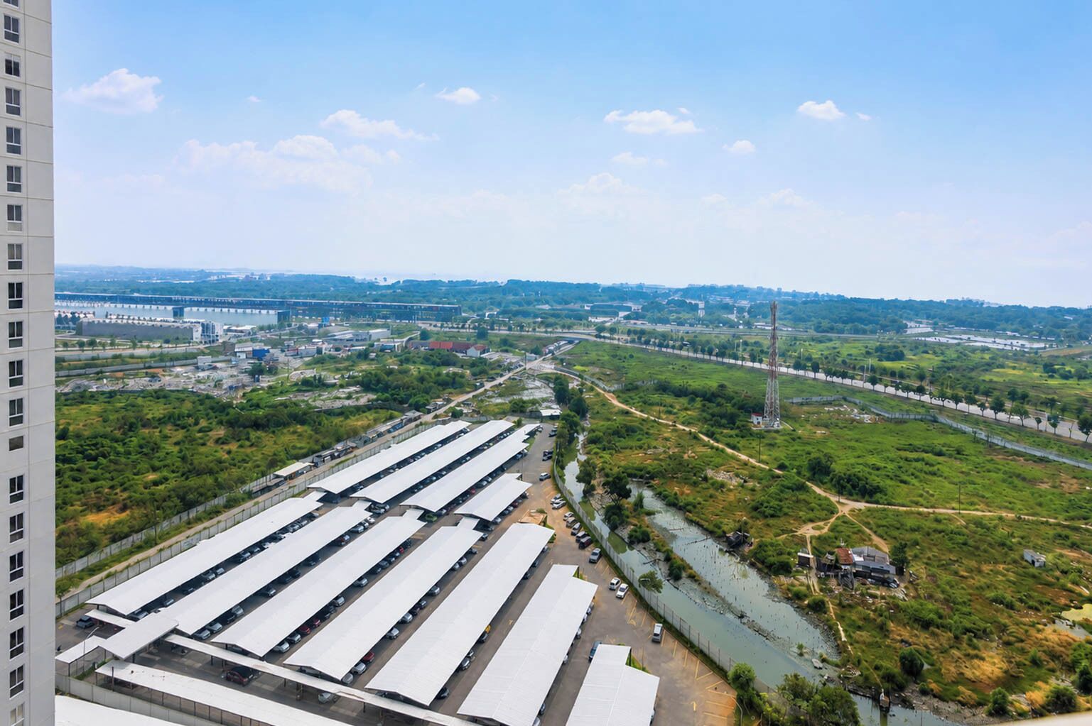 A large industrial area with multiple warehouses and a river.