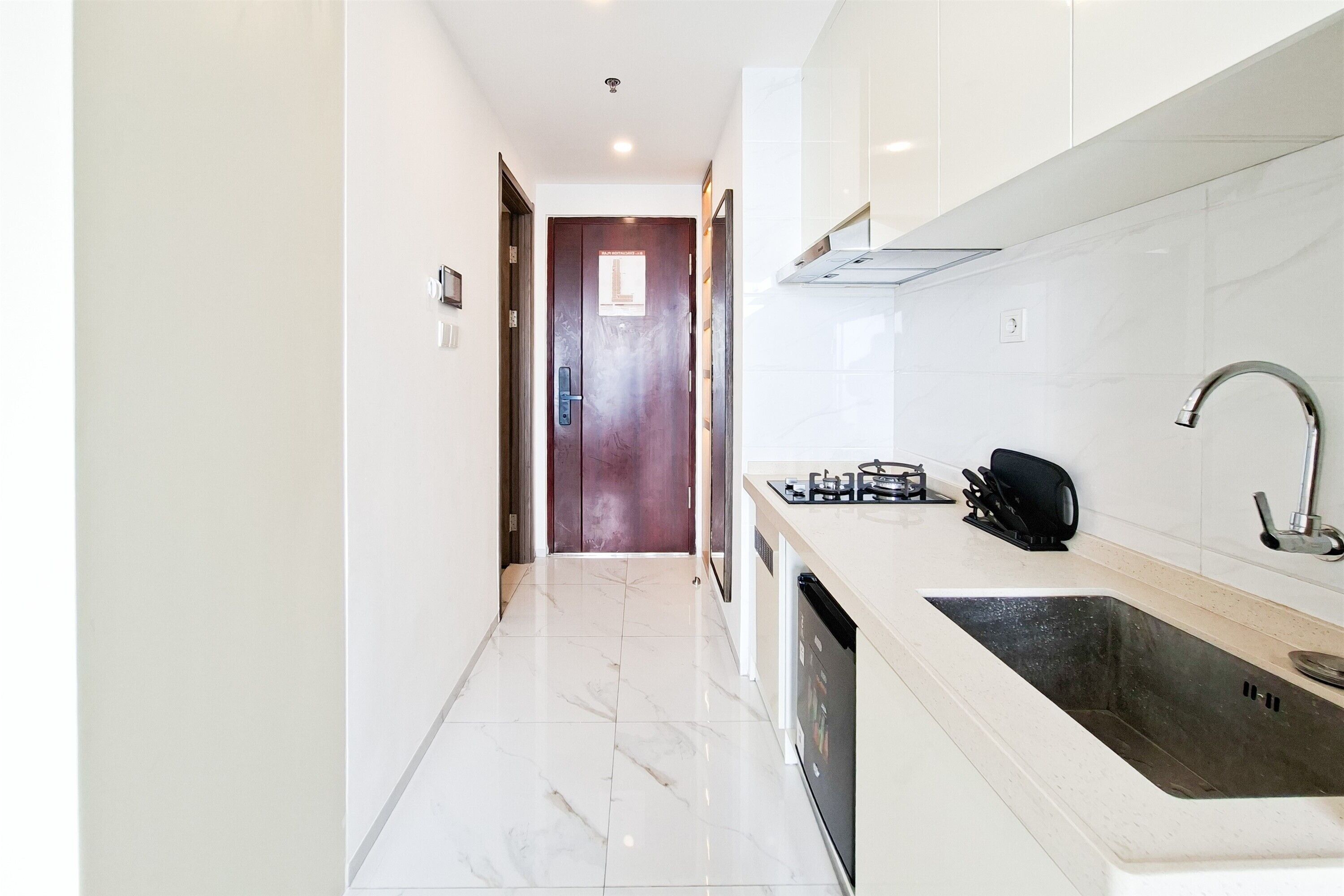 A kitchen with a dishwasher, a sink, and a stove.