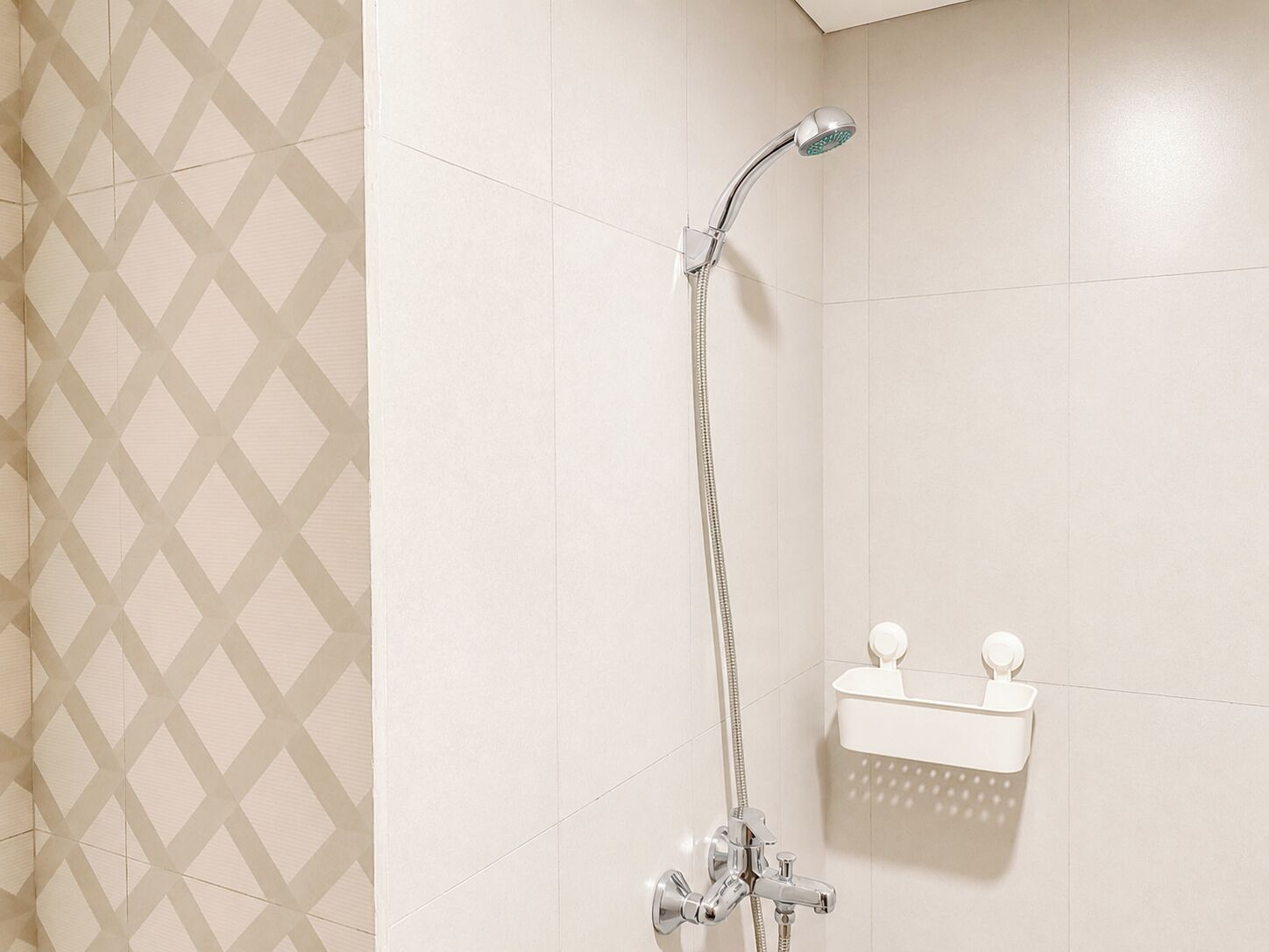 A bathroom with a shower, a toilet, and a towel rack.
